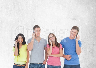 Group of friends talking on phones in front of blank grey background
