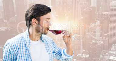 Man tasting wine against blurry skyline