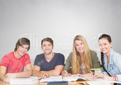 Group of students working and studying in front of grey background