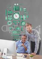 Happy business men at a desk using a computer against grey background with green graphic