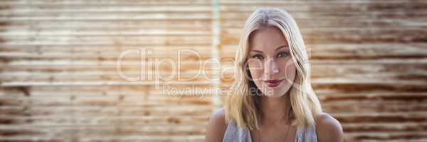 portraiture of woman smiling against blurry wood panel