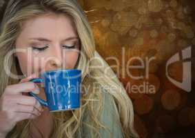 Portraiture of woman drinking coffee against brown bokeh