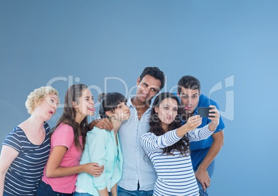 Group of people taking a funny silly selfie in front of blue background