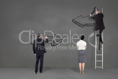 Business people drawing black arrows in a grey background