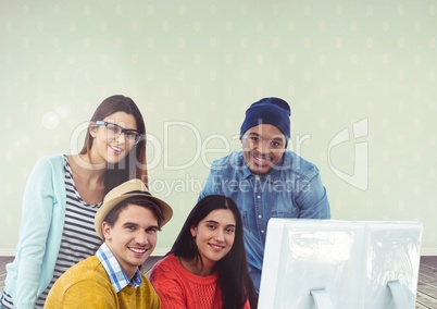 Group of people on laptop in front of bright background