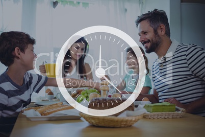 Clock icon against family having dinner photo