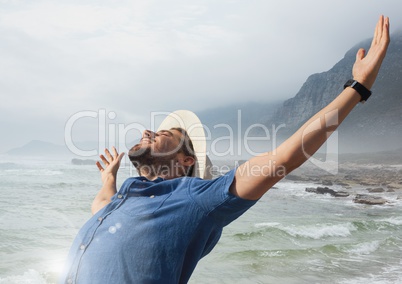 Man with open arms practicing casual mindfulness in front of sea landscape