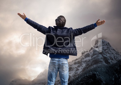 Man with open arms practicing casual mindfulness in front of Mountain tops