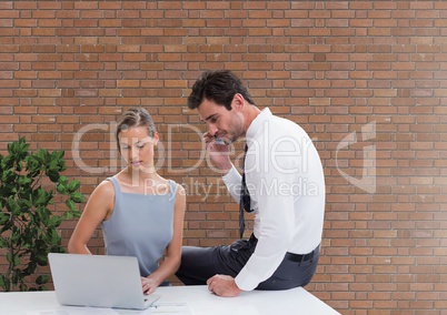 Business people at a desk looking at a computer