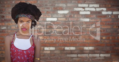 Hippie woman against blurry red brick wall