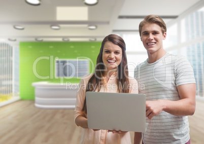 Happy business people holding a computer