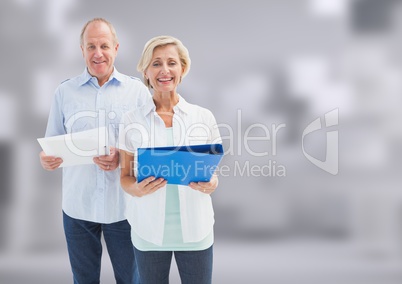 Old Students holding folder in front of blurred background