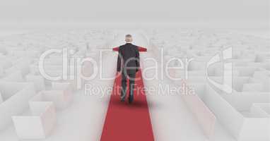 Businessman following red arrow walking through maze