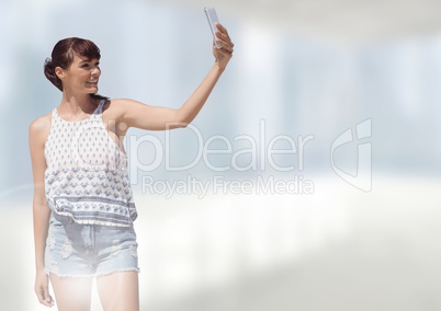 Woman taking casual selfie photo in front of blurred background