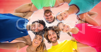 Low angle of millennials in circle against blurry red background