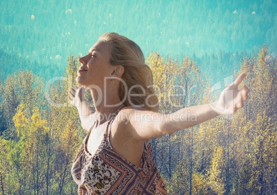 Woman with open arms practicing casual mindfulness in front of forest