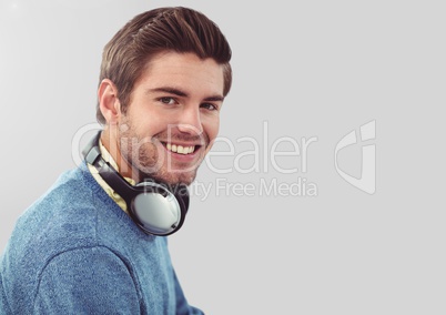 Portrait of Man wearing earphones with grey background