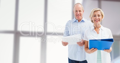 Old Students holding folders in front of blurred background