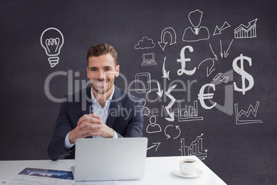 Happy business man at a desk using a computer against purple background with graphics