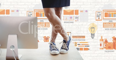 Business woman on a desk against white wall with orange graphics