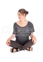 Woman sitting with closed legs on floor.