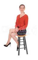 Young woman sitting on chair.