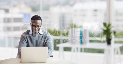 Happy business man at a desk using a computer