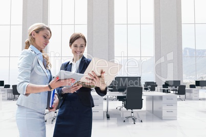 Happy business women looking at a computer