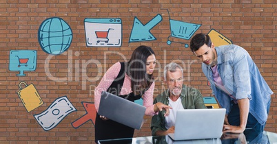 Business people at a desk looking at a computer against brick wall with graphics