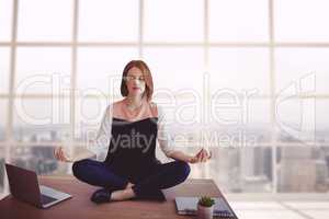 Business woman on a desk meditating
