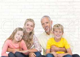 Family sitting in front of bright wall background