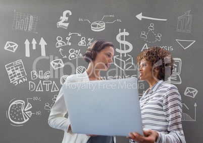 Business woman holding a computer against grey background with graphics