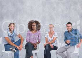 Group of people sitting in front of grey background