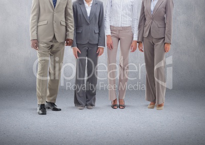 Group of business people standing in front of blank grey background