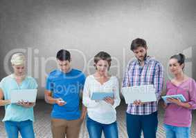 Group of friends standing in front of blank grey background with devices