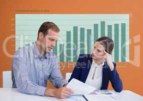 Business people at a desk looking at a paper against orange background with green graphics
