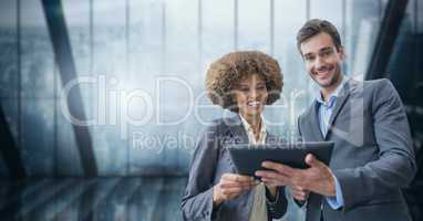 Happy business people holding a tablet
