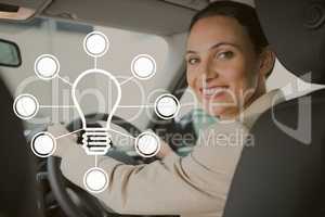 Bulb icon against woman driving photo