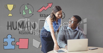 Happy business people at a desk using a computer against grey background with graphics Happy business people at a desk using a computer against grey background with graphics