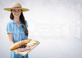 Woman with food platter against white wall