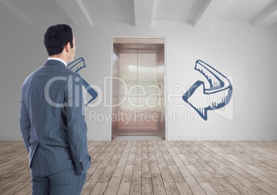 Business man standing against white room with blue arrows