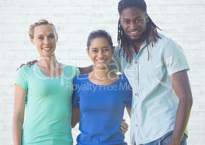 Group of people standing in front of blank bright brick background