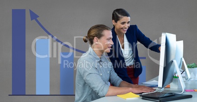 Business people at a desk using a computer against grey background with blue graphics