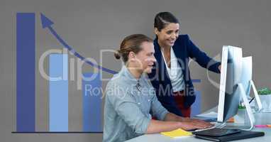 Business people at a desk using a computer against grey background with blue graphics