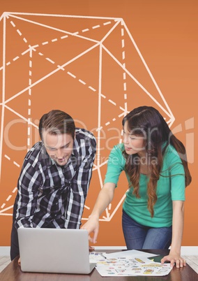 Business people at a desk pointing at a computer against orange background with graphic