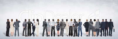 Group of business people standing in front of blank grey background