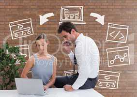 Business people at a desk looking at a computer against brick wall with graphics