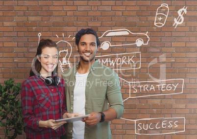 Happy business people holding a tablet against brick wall with graphics