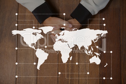 World map icon against hands on a table photo