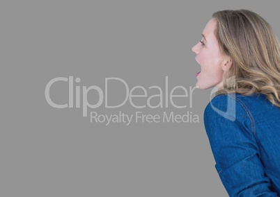 Portrait of woman shouting with grey background